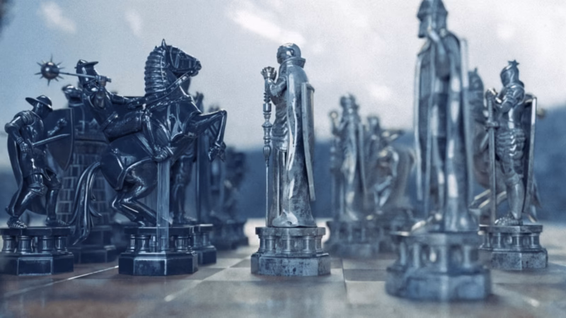 Be Ekhtesar chessboard scene with opposing rows of dark and silver figurative chess pieces beneath a cloudy sky.