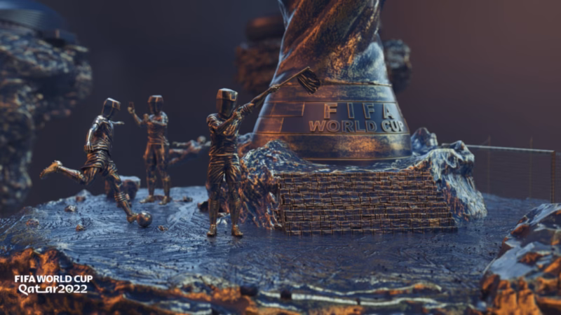 Qatar 2022 title artwork with bronze football figures, a ball and a giant FIFA World Cup trophy on a rocky platform